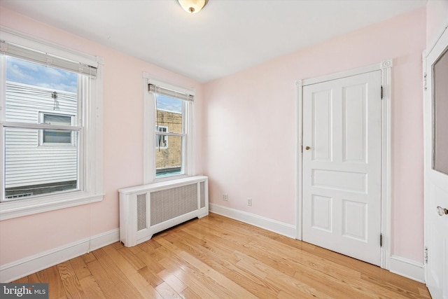 2410 S Camac St, Philadelphia, PA 19148 - empty room with radiator heating unit, baseboards, and light wood finished floors