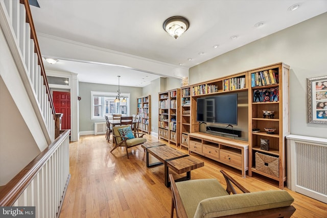2410 S Camac St, Philadelphia, PA 19148 - living area with an inviting chandelier, stairs, baseboards, radiator heating unit, and light wood-type flooring