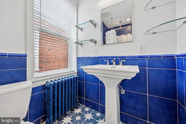 2410 S Camac St, Philadelphia, PA 19148 - bathroom featuring a wainscoted wall, radiator heating unit, a healthy amount of sunlight, and tile walls