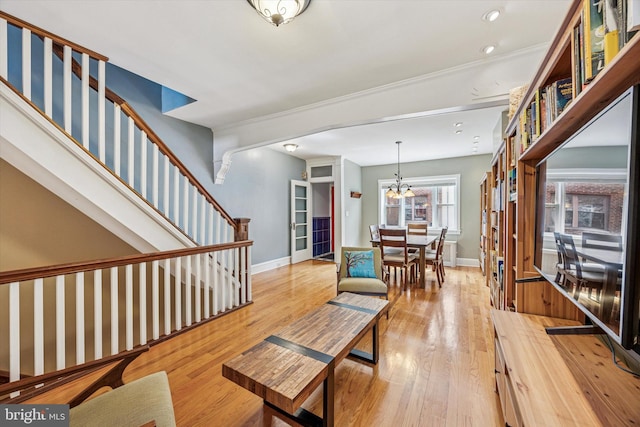 2410 S Camac St, Philadelphia, PA 19148 - living area featuring light wood-style floors, baseboards, and an inviting chandelier