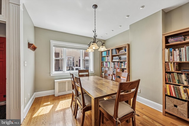 2410 S Camac St, Philadelphia, PA 19148 - dining space featuring light wood-style floors, radiator, baseboards, and a chandelier