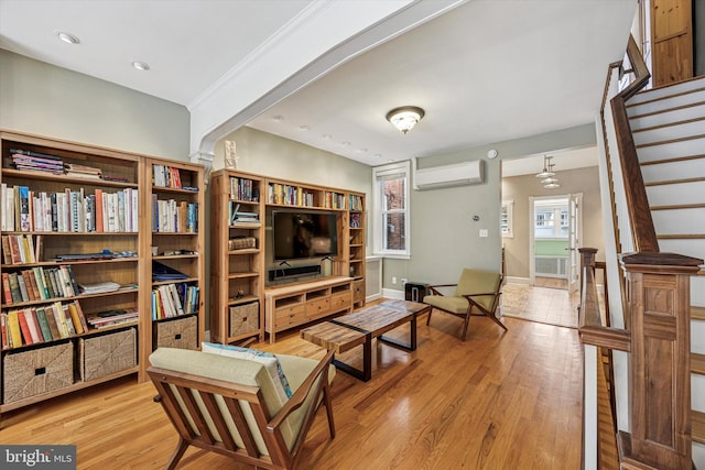2410 S Camac St, Philadelphia, PA 19148 - living room featuring baseboards, a wall unit AC, stairway, and light wood-type flooring
