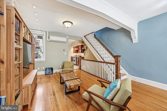 2410 S Camac St, Philadelphia, PA 19148 - sitting room with baseboards, a wall unit AC, wood finished floors, and stairway