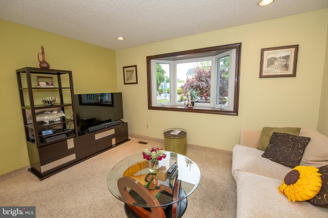 living room with carpet floors, a textured ceiling, and recessed lighting