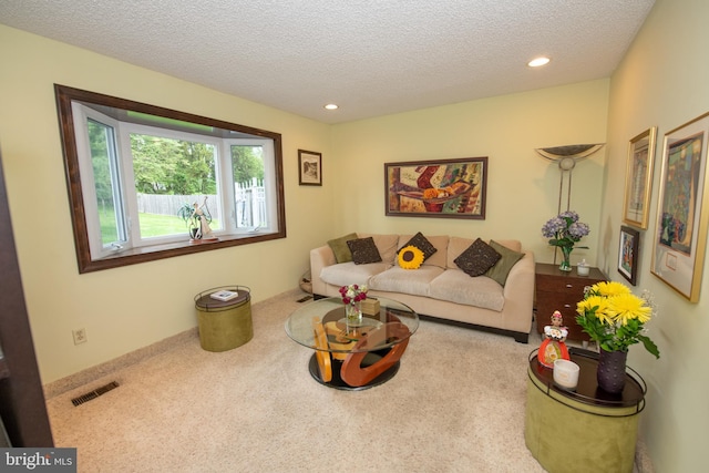 carpeted living room with a textured ceiling and recessed lighting