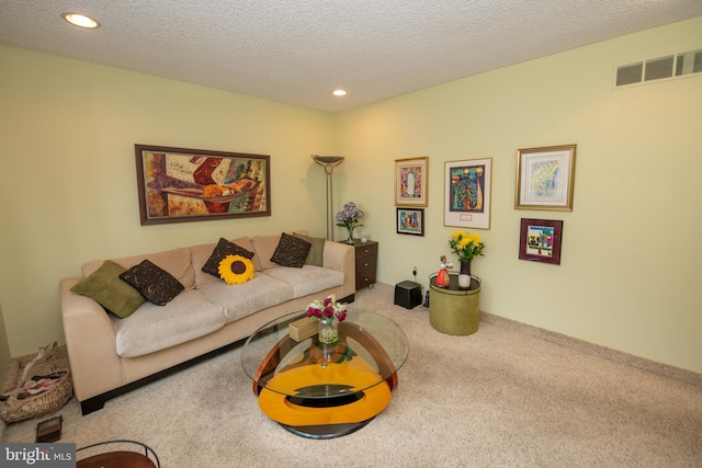 living room with carpet, recessed lighting, and a textured ceiling