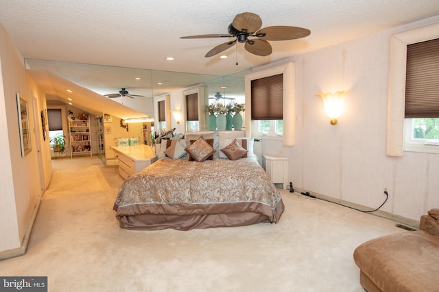 carpeted bedroom with recessed lighting and a textured ceiling