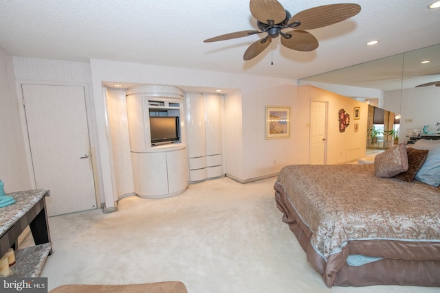 carpeted bedroom with recessed lighting and a textured ceiling