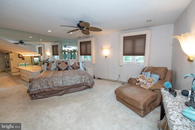 bedroom with light colored carpet and a textured ceiling