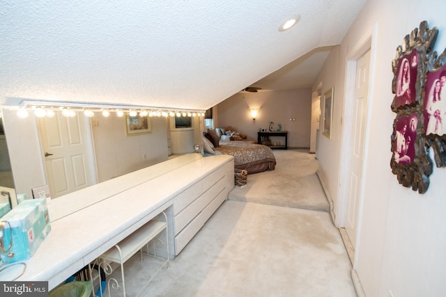 bedroom featuring light colored carpet and a textured ceiling