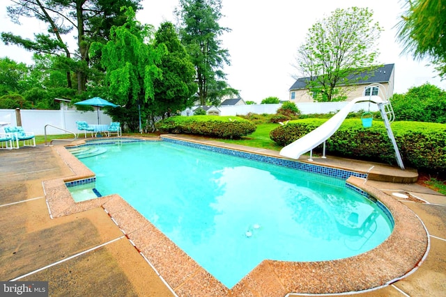 view of pool with a water slide, a fenced backyard, and a patio
