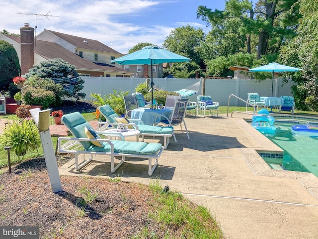 view of patio featuring outdoor dining area and fence