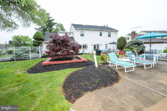 rear view of property featuring a patio, outdoor dining area, and a garden