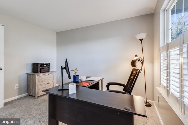 carpeted home office featuring baseboards and a healthy amount of sunlight