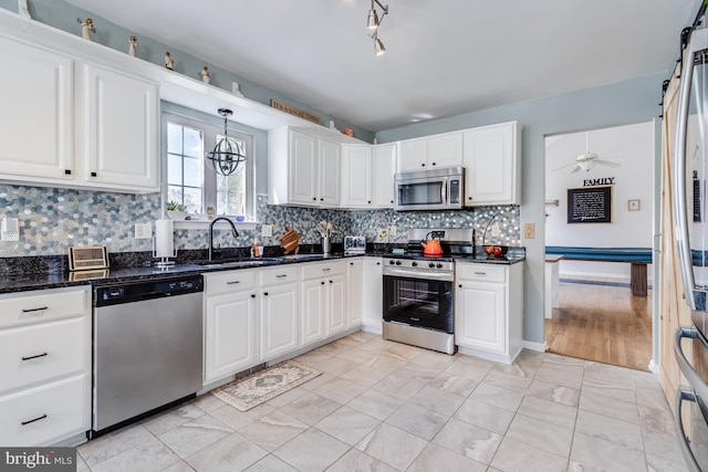 kitchen featuring a sink, white cabinets, and stainless steel appliances