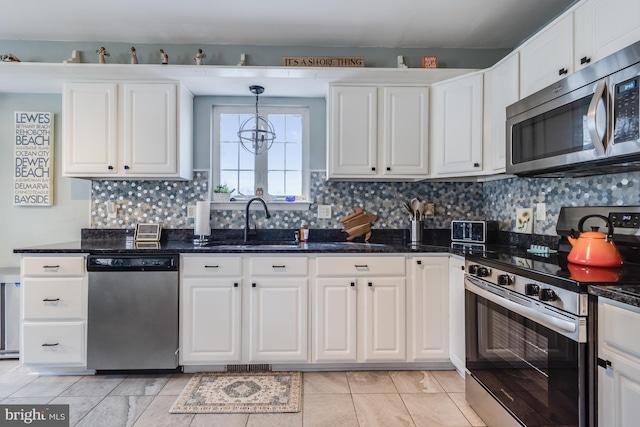 kitchen featuring backsplash, stainless steel appliances, white cabinetry, and a sink