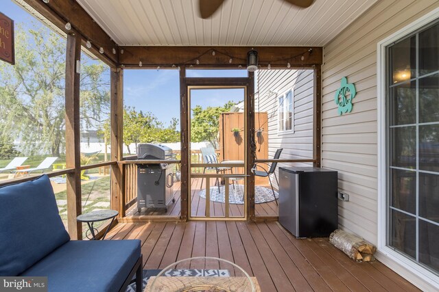 sunroom / solarium featuring ceiling fan and a wealth of natural light