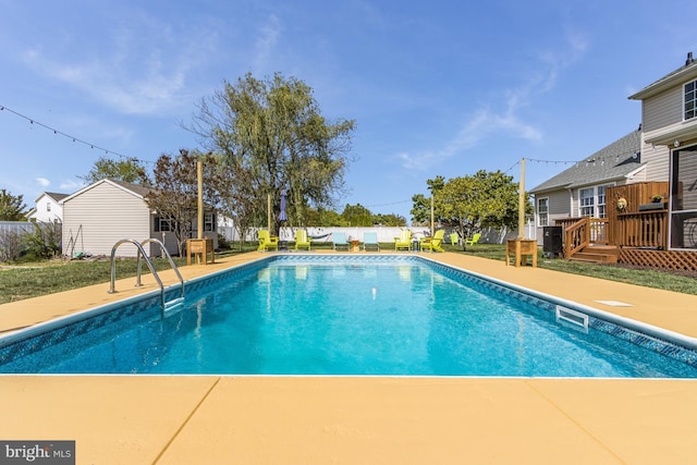 view of pool featuring a fenced in pool, a patio area, and a deck