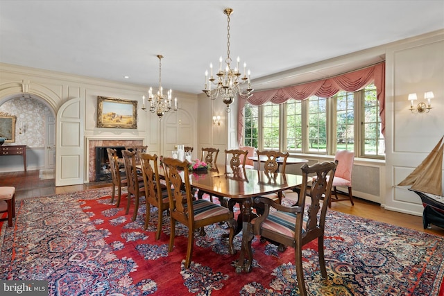 805 Evans Rd, Gwynedd Valley, PA 19437 - dining room featuring wood finished floors, a decorative wall, a fireplace, and a chandelier