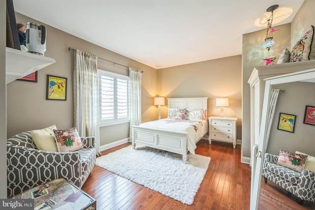 bedroom featuring baseboards and dark wood finished floors