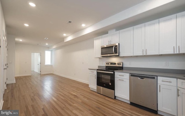 727 N 39th St, Philadelphia, PA 19104 - kitchen featuring light wood-style floors, white cabinetry, baseboards, and stainless steel appliances