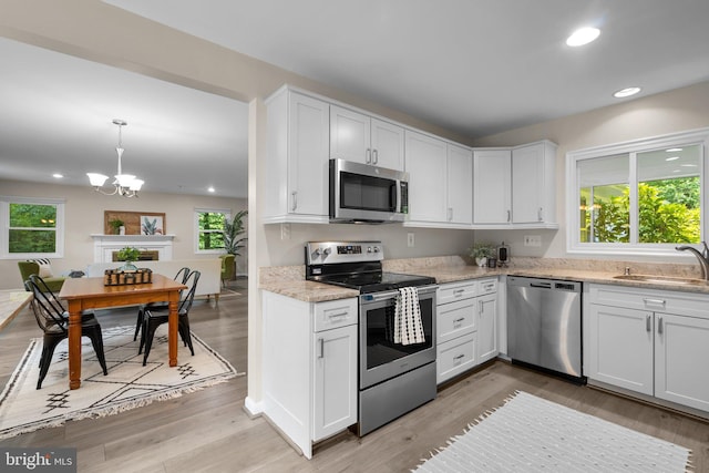 1725 Stratton Rd, Crofton, MD 21114 - kitchen featuring stainless steel appliances, a sink, a chandelier, recessed lighting, and light wood-style flooring