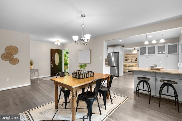 1725 Stratton Rd, Crofton, MD 21114 - dining room with light wood finished floors, a chandelier, baseboards, and ceiling fan