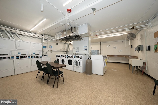 1030 E Lancaster Ave Unit 330, Bryn Mawr, PA 19010 - community laundry room with washing machine and dryer, a garage, a sink, stacked washer and dryer, and tile patterned floors