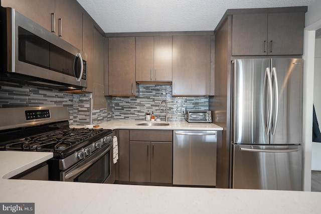 1030 E Lancaster Ave Unit 330, Bryn Mawr, PA 19010 - kitchen featuring a sink, backsplash, light countertops, and appliances with stainless steel finishes