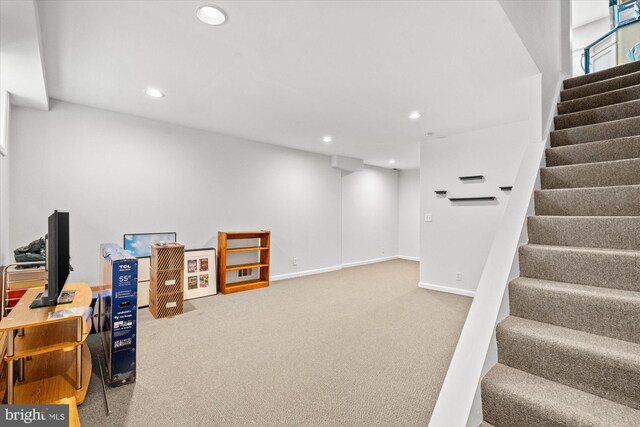 finished basement featuring recessed lighting, carpet, and stairway