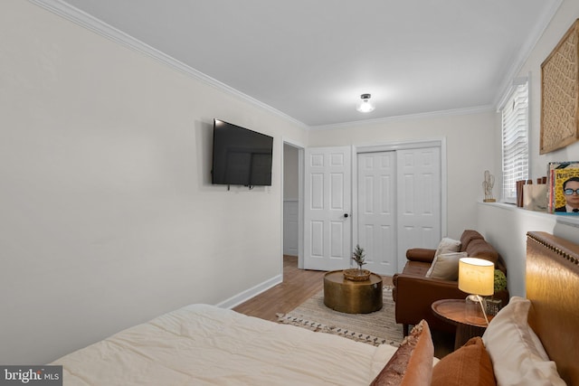 13405 Wisteria Dr, Germantown, MD 20874 - bedroom with ornamental molding, a closet, wood finished floors, and baseboards