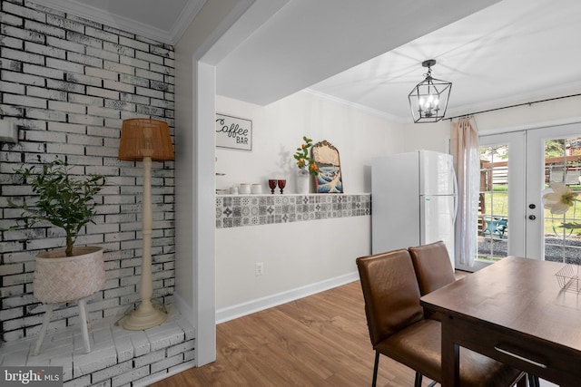 13405 Wisteria Dr, Germantown, MD 20874 - dining space with french doors, crown molding, wood finished floors, baseboards, and a chandelier