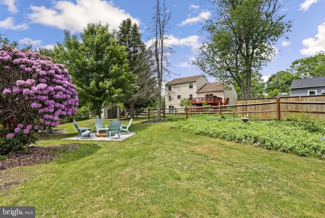 13405 Wisteria Dr, Germantown, MD 20874 - view of yard featuring a storage shed, a fire pit, an outdoor structure, and a patio area