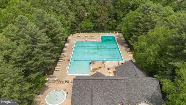 13405 Wisteria Dr, Germantown, MD 20874 - view from above of property with a pool area and a heavily wooded area