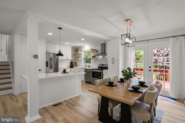 13405 Wisteria Dr, Germantown, MD 20874 - dining space featuring light wood-type flooring, stairway, recessed lighting, and french doors