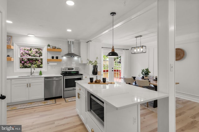 13405 Wisteria Dr, Germantown, MD 20874 - kitchen featuring appliances with stainless steel finishes, a sink, wall chimney exhaust hood, open shelves, and white cabinets