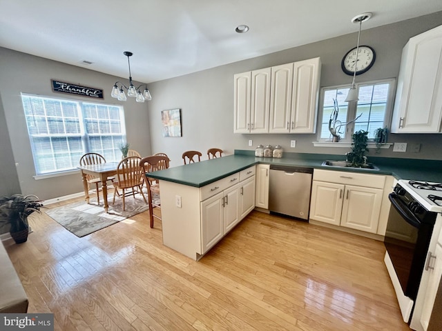 kitchen featuring an inviting chandelier, dishwasher, gas range, a peninsula, and light wood-type flooring