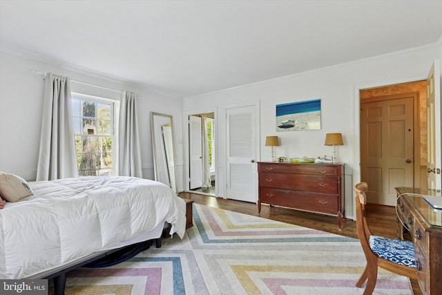 bedroom with dark wood-style flooring and ornamental molding