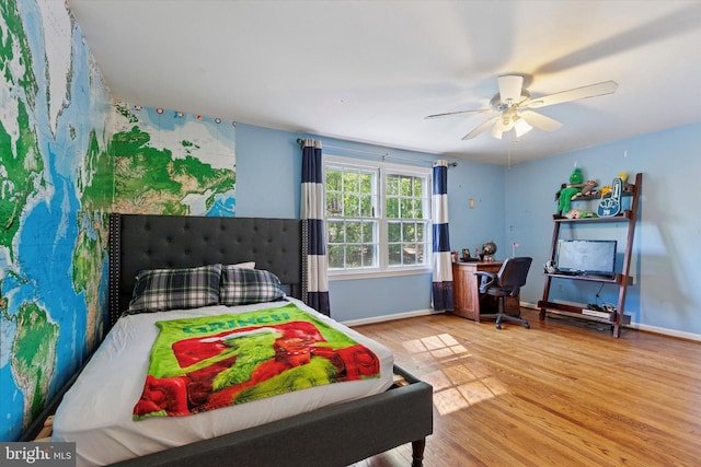 bedroom with baseboards, a ceiling fan, and wood finished floors