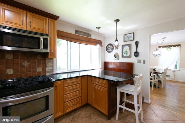 5 Gailridge Ct, Lutherville Timonium, MD 21093 - kitchen featuring stainless steel appliances, healthy amount of natural light, backsplash, and tile patterned floors