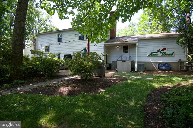 5 Gailridge Ct, Lutherville Timonium, MD 21093 - back of property with a chimney, central AC unit, and a lawn