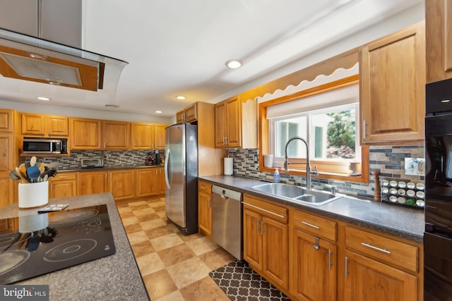 kitchen with backsplash, dark countertops, a sink, a toaster, and stainless steel appliances