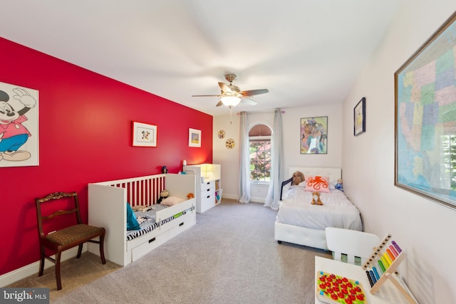 bedroom featuring baseboards, ceiling fan, and carpet