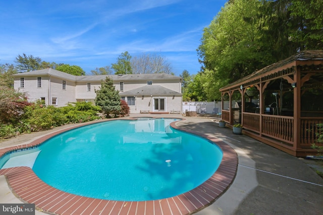 pool featuring fence, a patio, and a gazebo