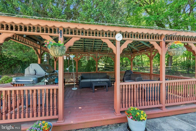 deck with an outdoor living space and a grill