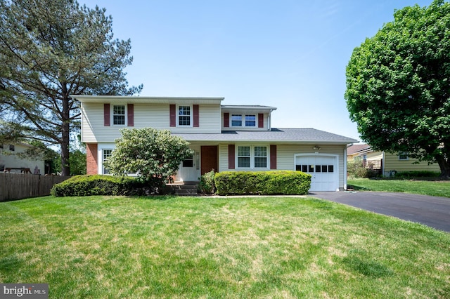 11 Whitekirk Dr, Wilmington, DE 19808 - traditional-style house featuring fence, an attached garage, aphalt driveway, a front yard, and covered porch