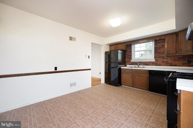 11 Whitekirk Dr, Wilmington, DE 19808 - kitchen with visible vents, a sink, black appliances, and light countertops