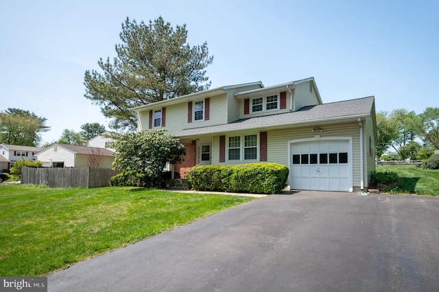 11 Whitekirk Dr, Wilmington, DE 19808 - traditional-style house featuring aphalt driveway, fence, a front yard, and a garage