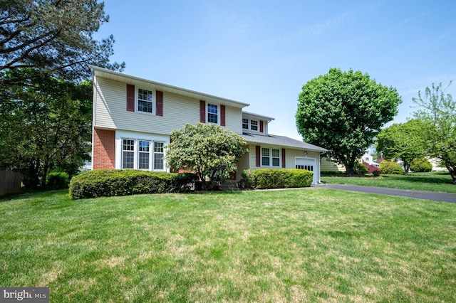 11 Whitekirk Dr, Wilmington, DE 19808 - view of front of home with an attached garage, a front lawn, aphalt driveway, and brick siding