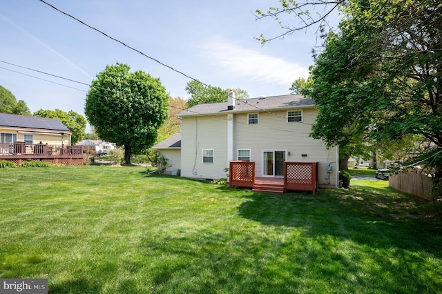 11 Whitekirk Dr, Wilmington, DE 19808 - back of property with a lawn, a deck, and a chimney